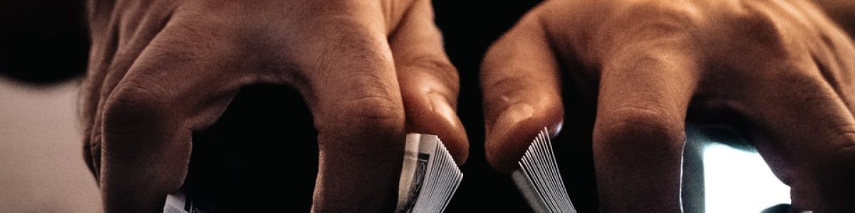 person wearing silver ring on macbook pro